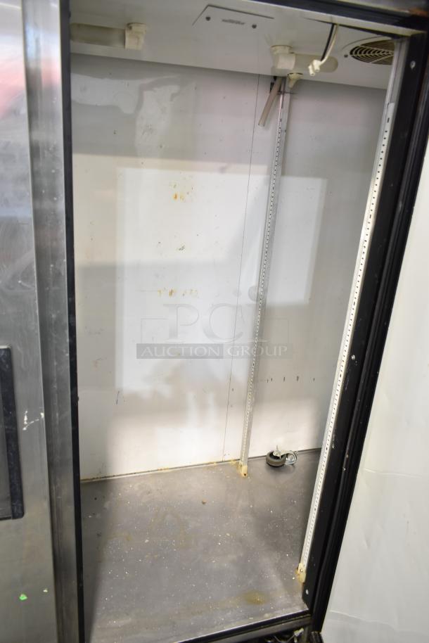 True Commercial 3 Door Reach In Cooler, 115 Volts, 1 Phase. Interior condition shows wear with visible residue and scratches.