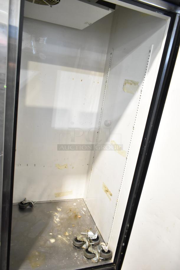 True Commercial 3 Door Reach In Cooler, interior view showing shelves, 115 volts, 1 phase, appears used, some scuffs visible.