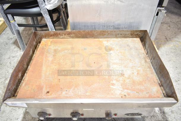 Star commercial countertop electric griddle with flat top, rusted surface, and three control knobs. Model details visible on badge.