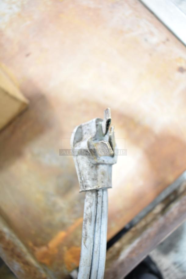 Electric plug of a Star Commercial Countertop Flat Top Griddle, showing signs of use.