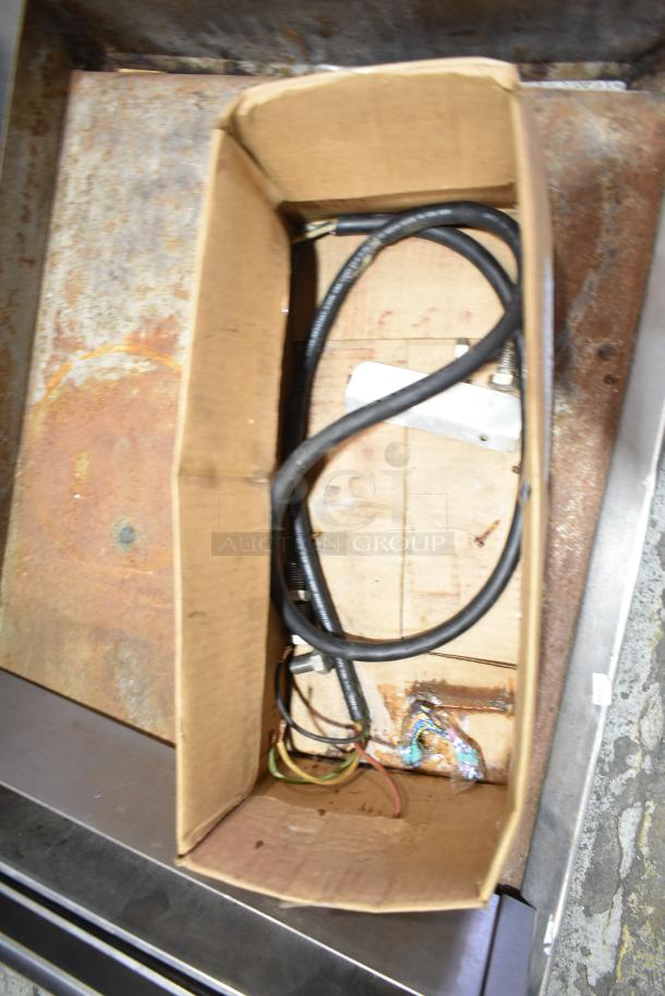 Box with electrical cables and hardware for Star Commercial Countertop Electric Flat Top Griddle, showing potential wear.