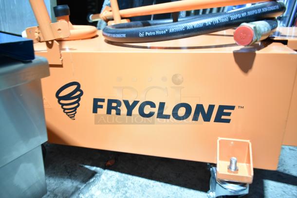BRAND NEW SCRATCH AND DENT Fryclone 100 lb. fryer oil disposal unit, orange color, visible logo, attached hose.