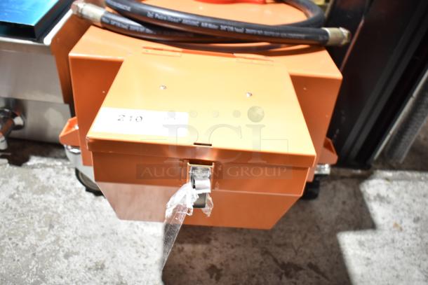 BRAND NEW SCRATCH AND DENT Fryclone 100 lb. fryer oil disposal unit, visible label "210", orange, includes hose.