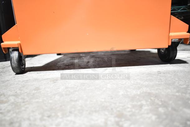 Brand new Fryclone 100 lb. fryer oil disposal unit on wheels, scratch and dent condition, orange exterior.