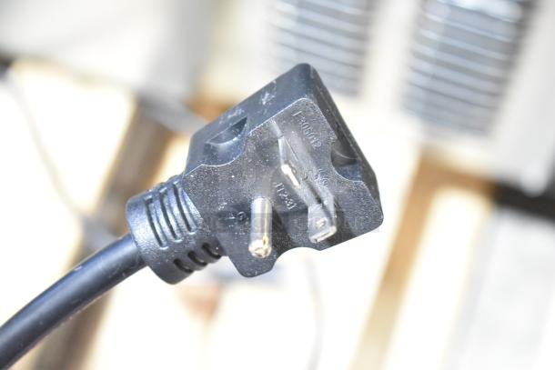 Close-up of a black power plug for the Avantco 177F202 dual tank electric countertop fryer.