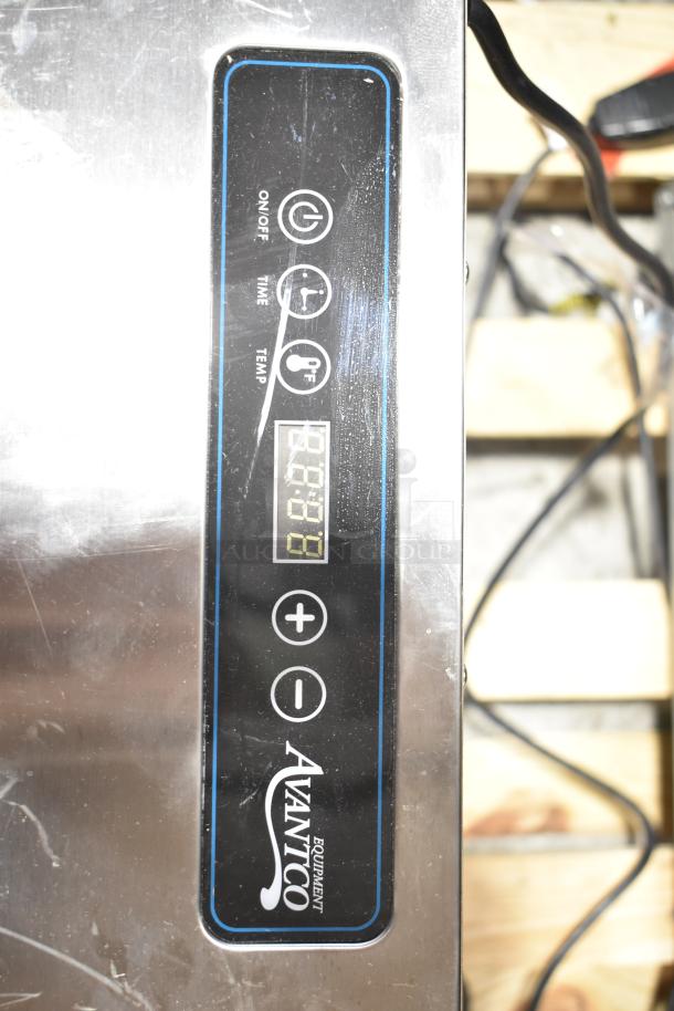 Brand new Avantco 177LT93 24 Tray food dehydrator in stainless steel with glass door, digital controls, 120V, scratches visible.