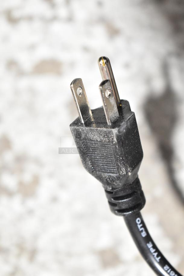 Close-up of a three-pronged power plug for the RiceMaster Town 56919 rice warmer, rated at 120 volts.