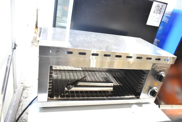 Brand new Avantco 177CHSME24IA 24" electric countertop cheese melter; scratch and dent, 120 volts, 1 phase, knobs visible.