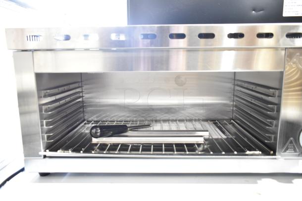 Brand new Avantco 177CHSME24IA 24" electric countertop cheese melter, 120V, 1 phase, with minor dents.