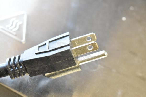 Close-up of the power plug from a 24" Avantco 177CHSME24IA Electric Cheese Melter, showing standard 120-volt compatibility.