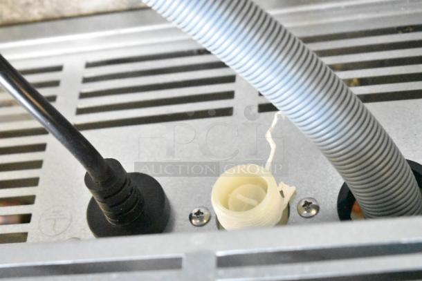 Alt text: Close-up of Avantco 194UCH210A undercounter ice machine wiring and hose connections, showing new condition.