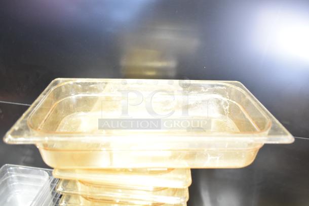 Stacked transparent containers with lids and drop-in bins, slightly used, showcasing a variety of storage solutions.