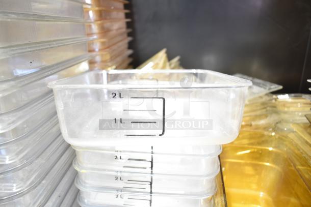 Clear plastic containers with 2L marking, stacked with lids and drop-in bins, in good condition.