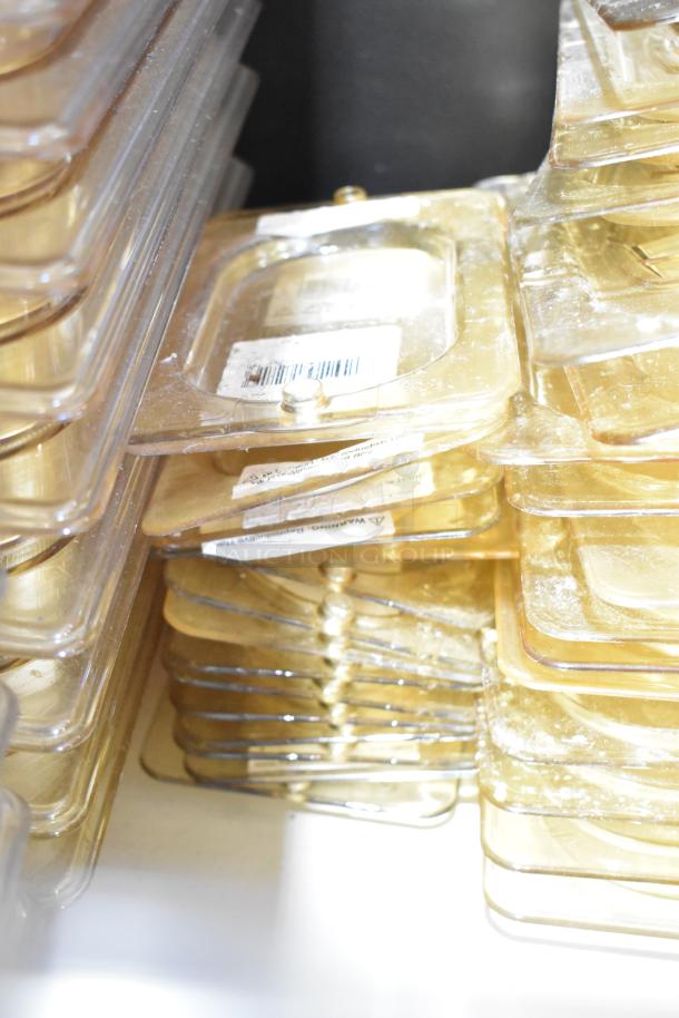 Stacked clear plastic containers and lids with visible barcode labels, showing light wear, suitable for storage needs.