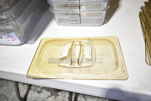 Lot of various items including clear food containers, drop in bins, and lids on a white surface, showing light wear.