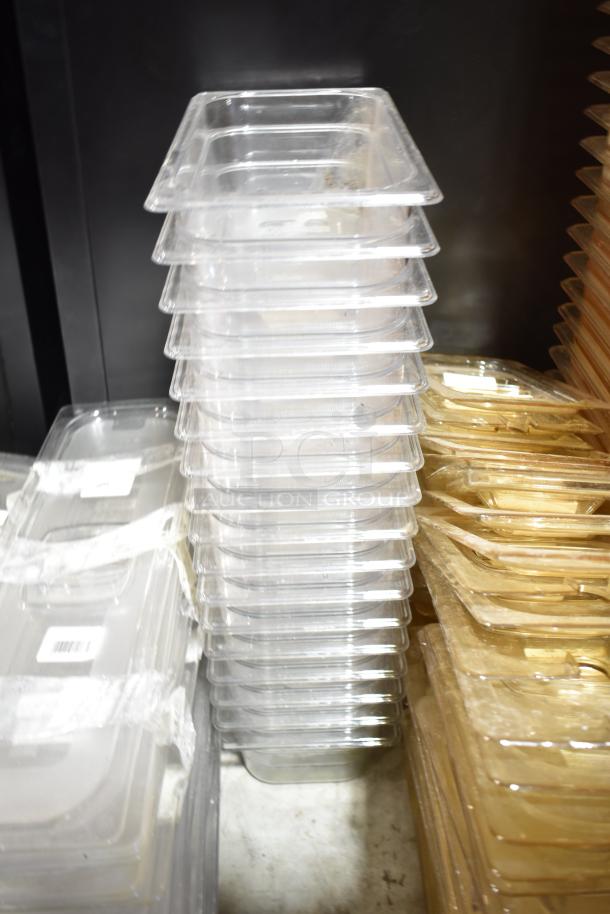 Lot of clear and amber drop-in bins with lids, stacked. Mixed condition; visible barcodes on some items.
