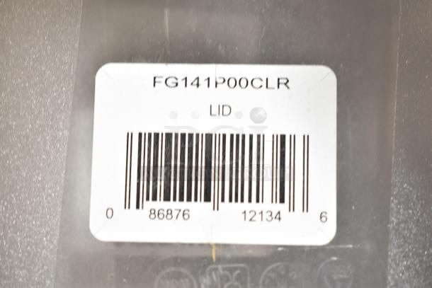 Barcode label indicating "FG141P00CLR LID" on a plastic surface, part of a lot including bins and lids.