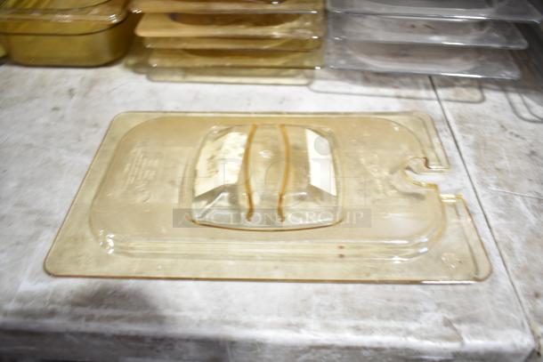Lot of drop-in bins and lids, mostly beige and translucent, stacked on a countertop, showing wear and discoloration.