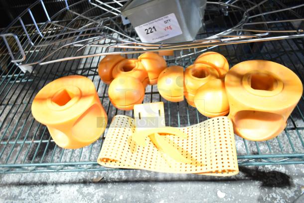 Eight yellow citrus juicer pieces on a metal shelf, varying shapes, durable plastic, labeled "221." Great for efficient juicing.
