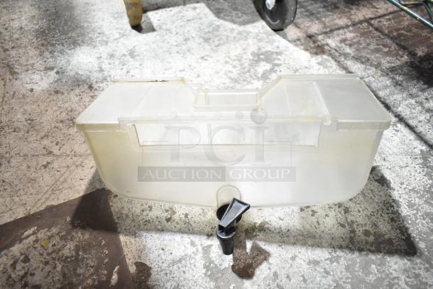 Clear plastic citrus juicer container with tap, part of a set of 8, showing signs of wear; ideal for juicing machines.