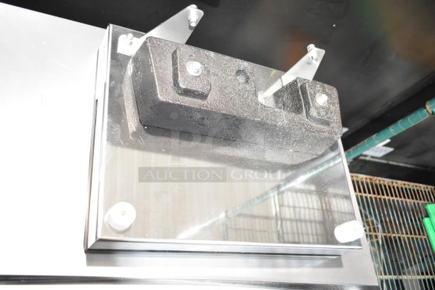 Industrial panel with metal brackets and protective covering, featuring secure mounting bolts. Appears in good condition.