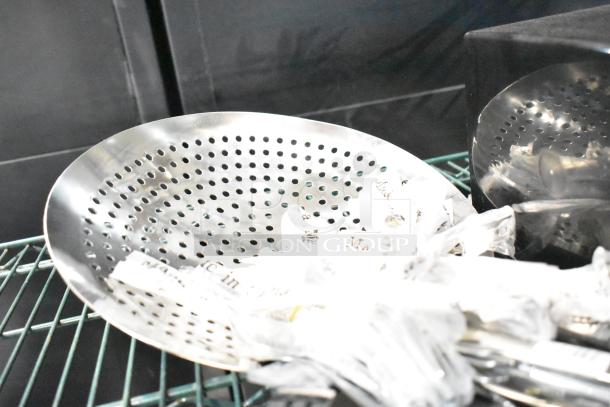 Lot includes a perforated metal colander and wrapped utensils on a wire shelf. Good condition, markings indistinguishable.