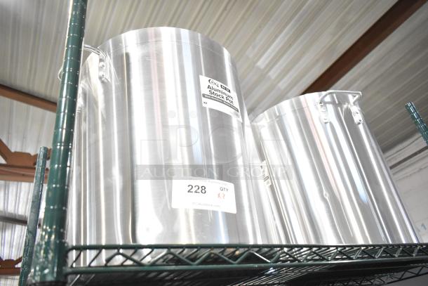 Two brand new Choice 471SP60QT aluminum stock pots, 60 qt, with minor scratches and dents, on a metal shelf.