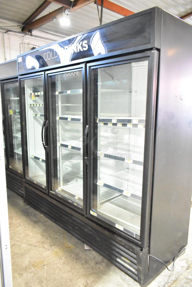True GDM-72-HC commercial 3-door reach-in cooler. Black exterior, glass doors, interior shelves. 115 volts, 1 phase.