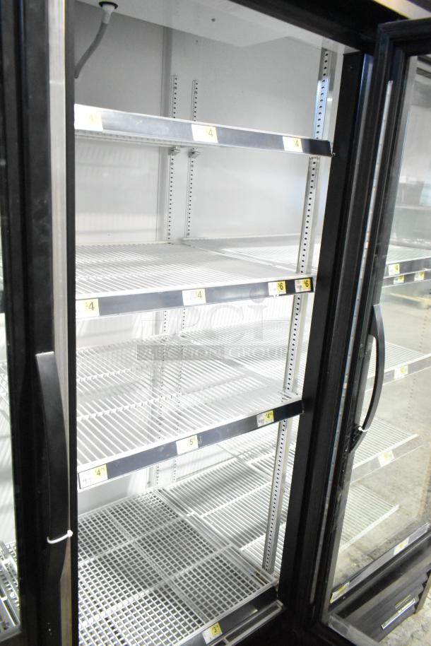 True GDM-72-HC commercial 3-door reach-in cooler merchandiser, clean interior, adjustable shelves, 115 volts, 1 phase.