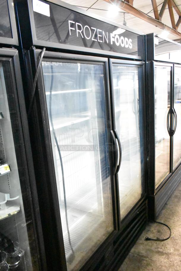 2020 True GDM-49F-HC commercial freezer, 2 glass doors, black frame, "Frozen Foods" sign, 115V, 1 phase.