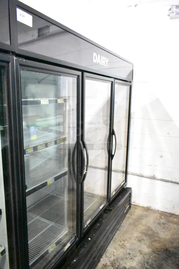 2019 True GDM-72-HC commercial 3-door reach-in cooler, 115 volts, "DAIRY" label, glass doors, metal shelves.