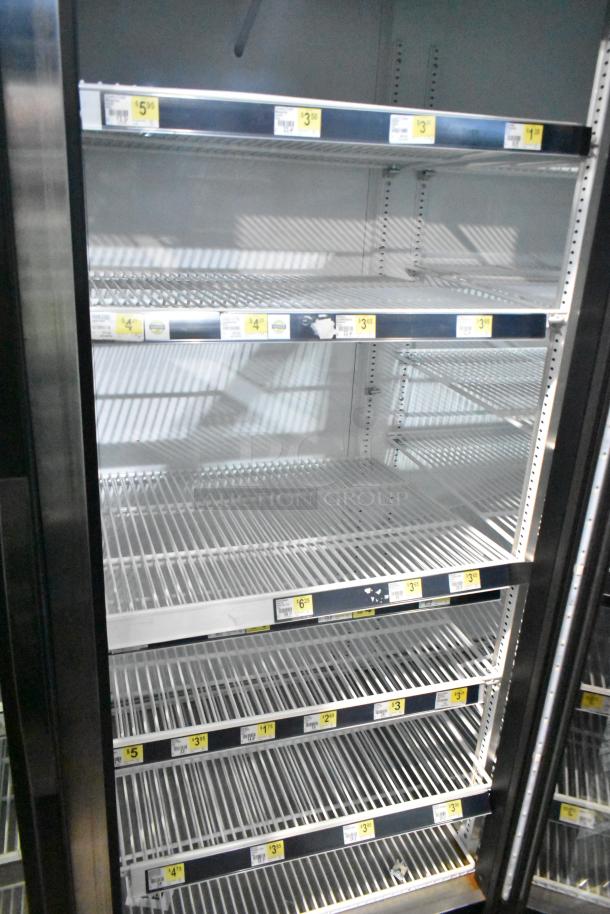 2019 True GDM-72-HC commercial cooler, 3 glass doors, 115V, 1 phase. Shelves with pricing labels visible.