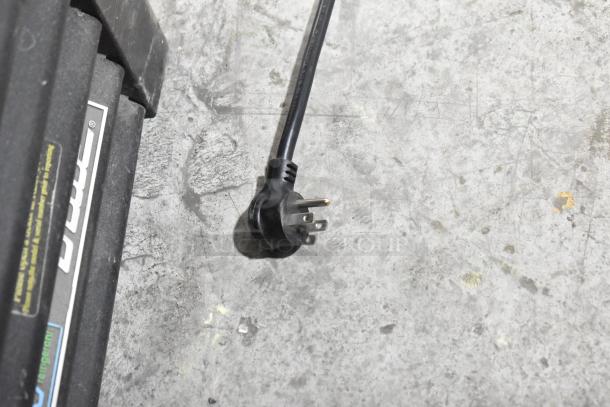 Electrical plug for 2019 True GDM-72-HC Commercial Reach-In Cooler, 115V, 1 Phase, shown on a concrete floor.