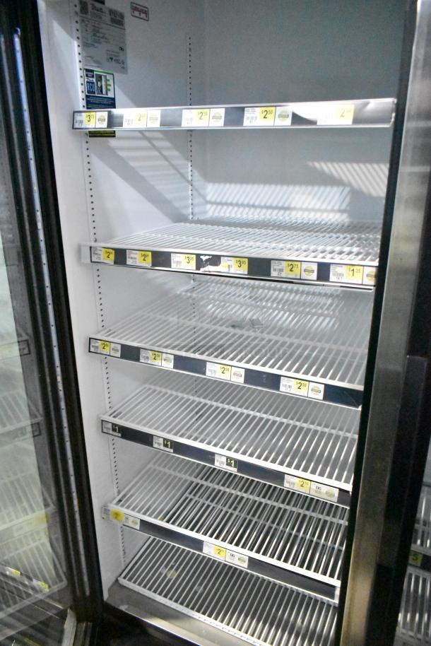 2019 True GDM-72-HC 3 Door Cooler Merchandiser, 115 Volts, with multiple shelves, visible energy efficiency labels.