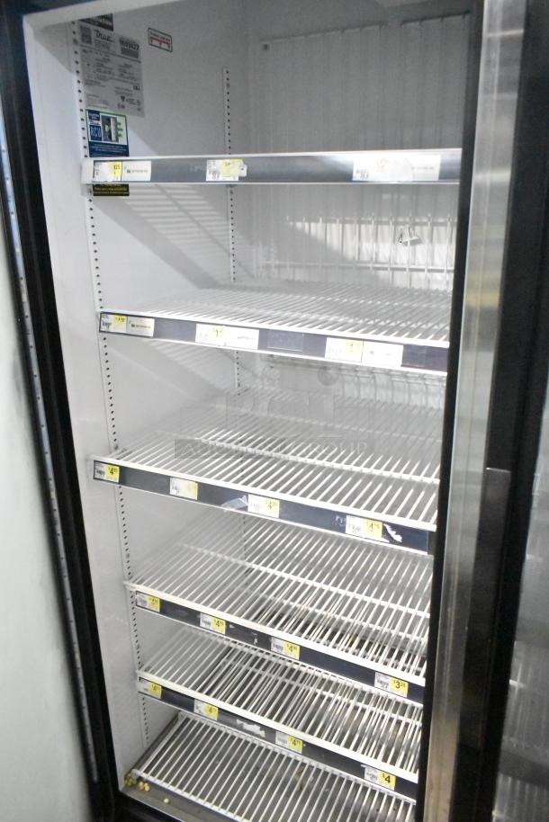 2019 True GDM-72F-HC 3-door reach-in freezer merchandiser, 115 volts, 1 phase, visible price tags on shelves.