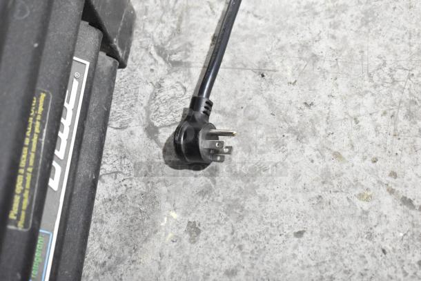 Power plug of the 2019 True GDM-72F-HC freezer shown on a concrete floor. True branding visible.