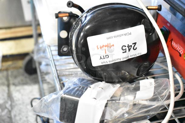 BRAND NEW SCRATCH AND DENT motor with visible label "245, 1 Warrant", in original condition on storage shelf.