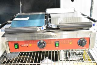 Brand new Avantco 177PG400S commercial dual panini grill with smooth plates, 19 5/8"x9 1/8" surface, 120V, 1 phase.