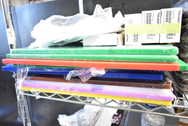 Assorted brand new scratch and dent items, including colored cutting boards and Vollrath dishers, shown on a metal shelf.
