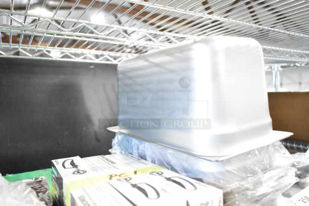 Stainless steel drop-in bin on shelf, part of 34 new scratch and dent kitchenware items including cutting boards and dishers.