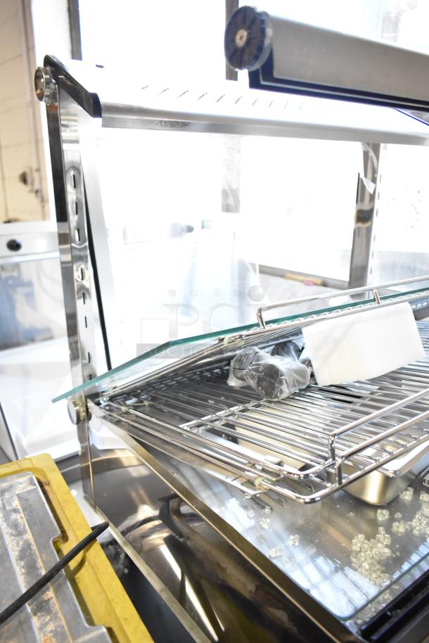 Brand new ServIt HDM-26, 26" heated display case, 3 shelves, sliding doors, some visible scratches and dents, 120V, 1 phase.