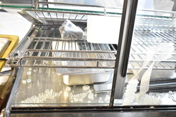 Brand new ServIt HDM-26, 26" heated display case, 3 shelves, sliding doors, some visible scratches and dents, 120V, 1 phase.