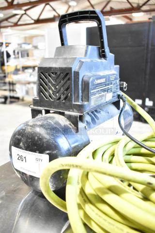 2016 Husky 0100211A Air Compressor by ServIt, black color, visible model label, hose included, good condition.