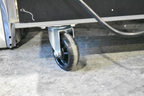 Alt text: Close-up of a caster wheel on a brand new KoolMore RIR-3D-SS three-door refrigerator, indicating mobility features.