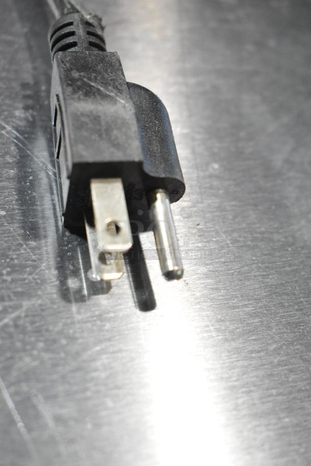 Power plug for Cooler Depot SD105B Commercial Cooler, 110-120 Volts, 1 Phase, shown on a metallic surface.