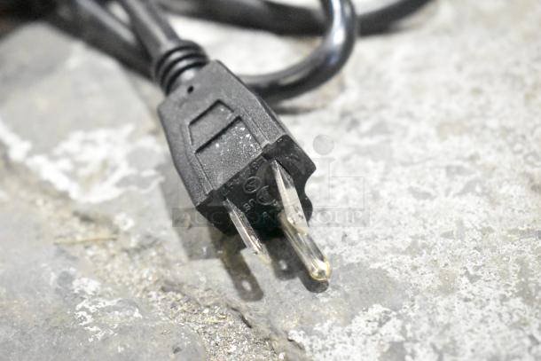 A close-up of a power cord and plug for the Carnival King JETCOF 240M beverage dispenser.