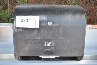 Georgia Pacific wall mount paper towel dispenser, black, used condition, visible logo and auction tag.