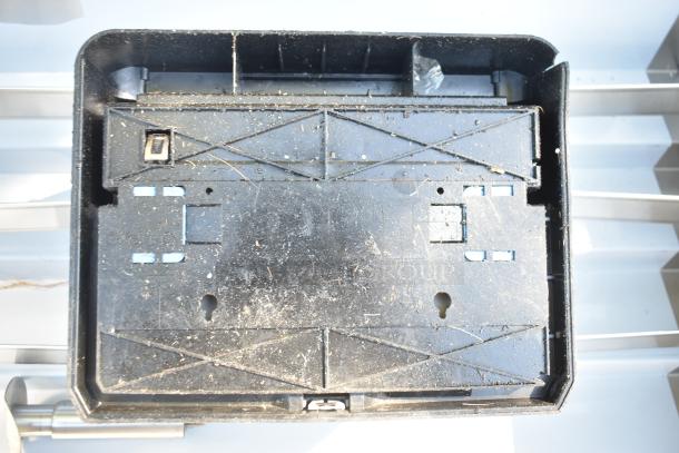 Georgia Pacific wall mount paper towel dispenser, black, pre-owned with visible wear and dust.