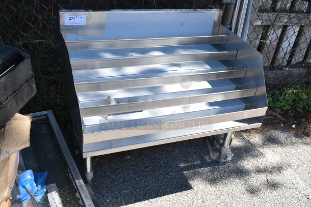 Brand new commercial bottle display rack, stainless steel, with minor scratches and dents, price tag visible.