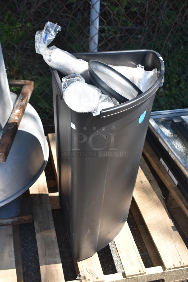 Rooftop mushroom exhaust fan and black poly trash can on wooden pallet, includes duct parts in packaging.